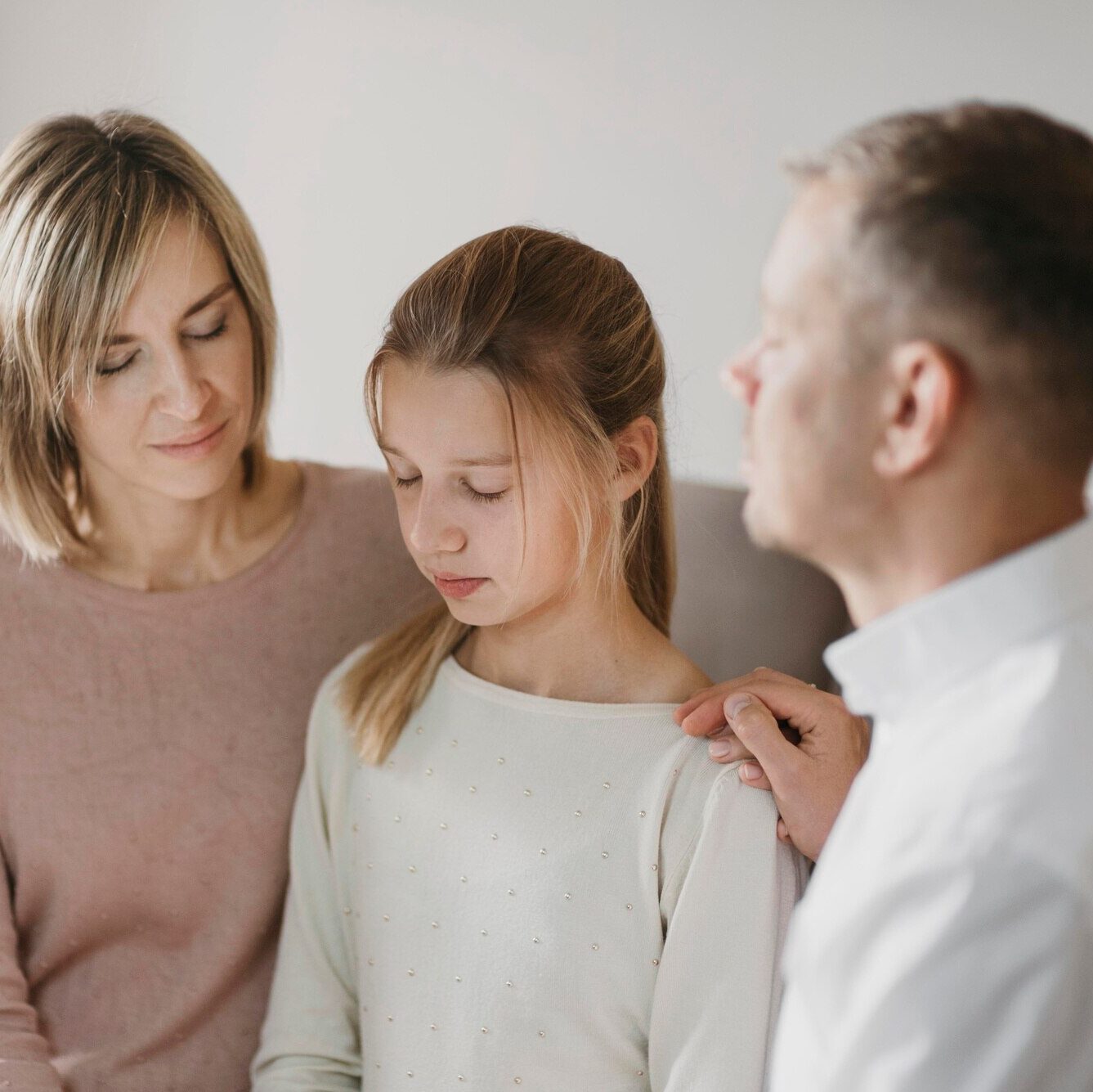 parents-daughter-praying-together_23-2148769394